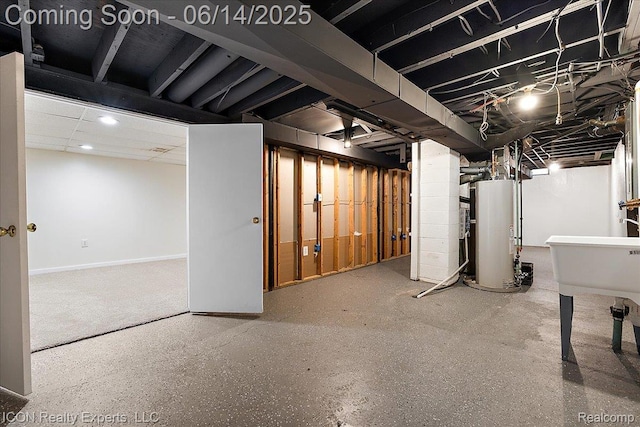 2570 Tarry Dr, Macomb, MI 48310 - unfinished below grade area with gas water heater, a sink, baseboards, and recessed lighting