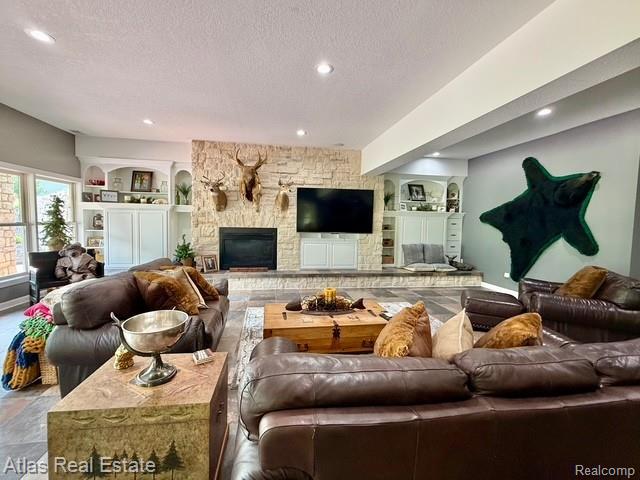 5415 Walker Rd, Davison, MI 48423 - living area with a fireplace, a textured ceiling, built in features, and recessed lighting