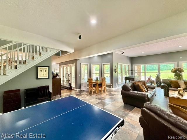 5415 Walker Rd, Davison, MI 48423 - playroom featuring french doors, stone finish flooring, baseboards, and recessed lighting