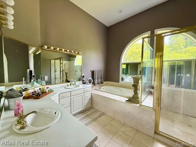 5415 Walker Rd, Davison, MI 48423 - full bathroom featuring double vanity, a garden tub, tile patterned flooring, and an enclosed shower
