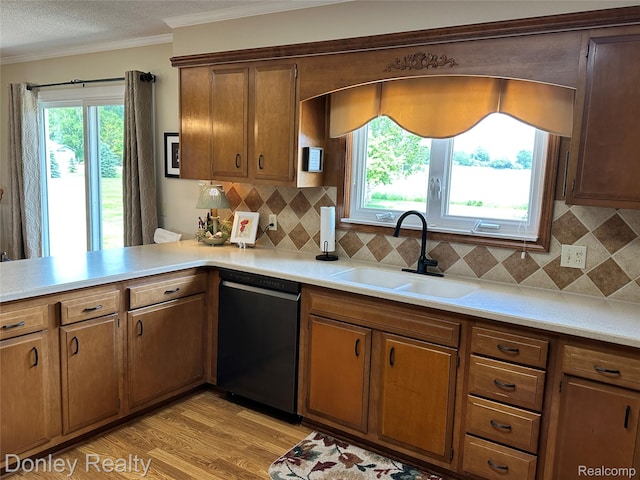 250 N Decker Rd, Snover, MI 48727 - kitchen featuring dishwasher, a sink, ornamental molding, light countertops, and decorative backsplash