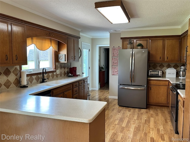 250 N Decker Rd, Snover, MI 48727 - kitchen featuring freestanding refrigerator, black electric range, a sink, light countertops, and a textured ceiling