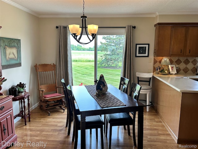 250 N Decker Rd, Snover, MI 48727 - dining area featuring a chandelier, light wood-type flooring, ornamental molding, and baseboards