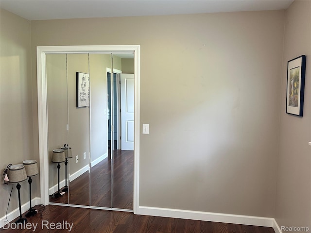 250 N Decker Rd, Snover, MI 48727 - unfurnished bedroom with wood finished floors, baseboards, and a closet