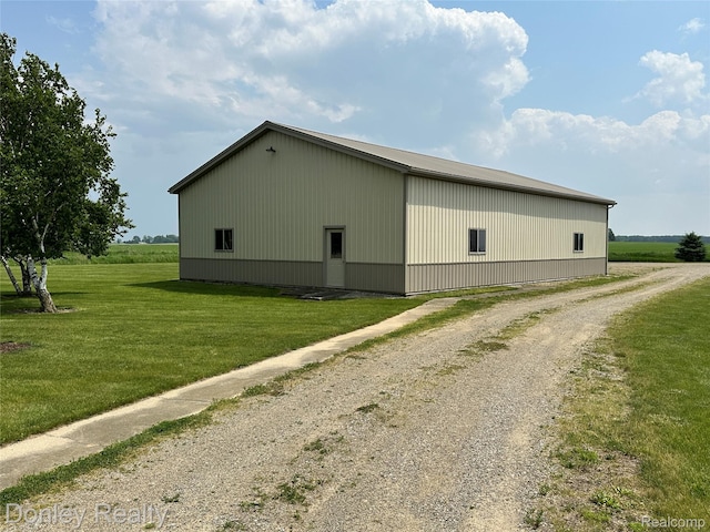 250 N Decker Rd, Snover, MI 48727 - view of property exterior featuring an outbuilding, a yard, and gravel driveway