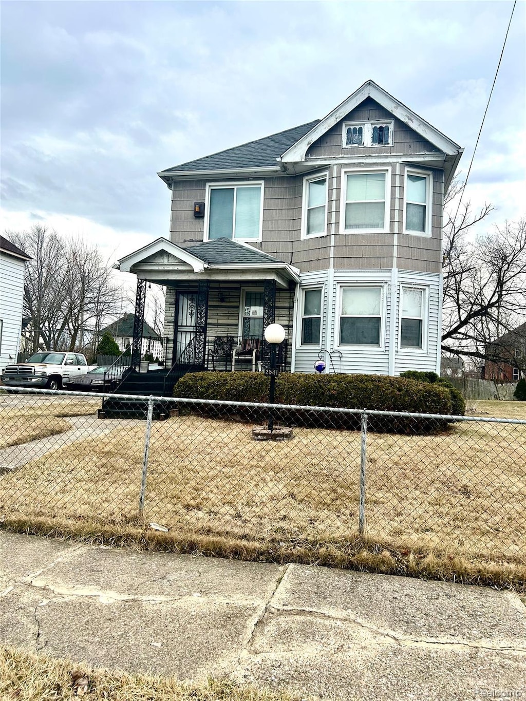 2541 Garland St, Detroit, MI 48214 - multi unit property featuring a fenced front yard, a porch, and roof with shingles