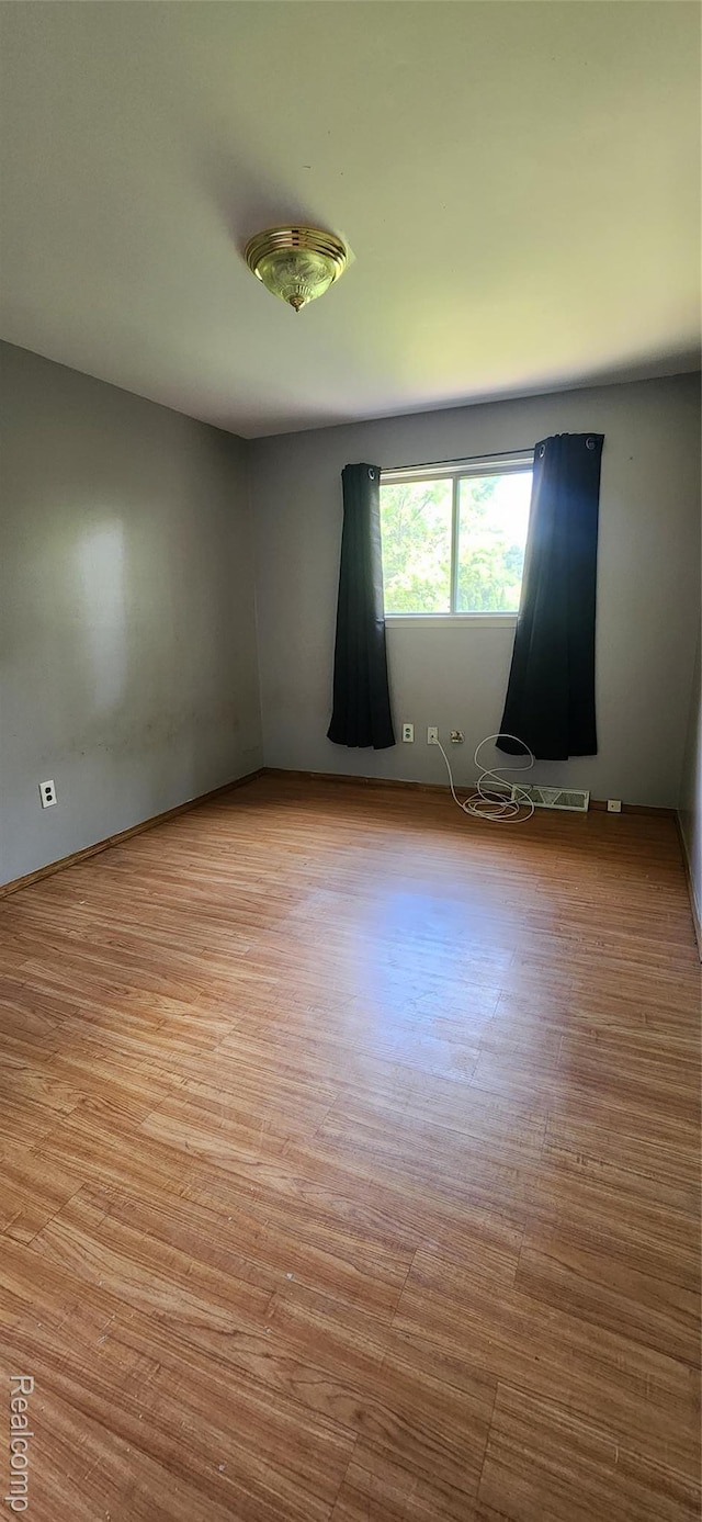 7040 Banks, Waterford, MI 48327 - spare room featuring wood finished floors