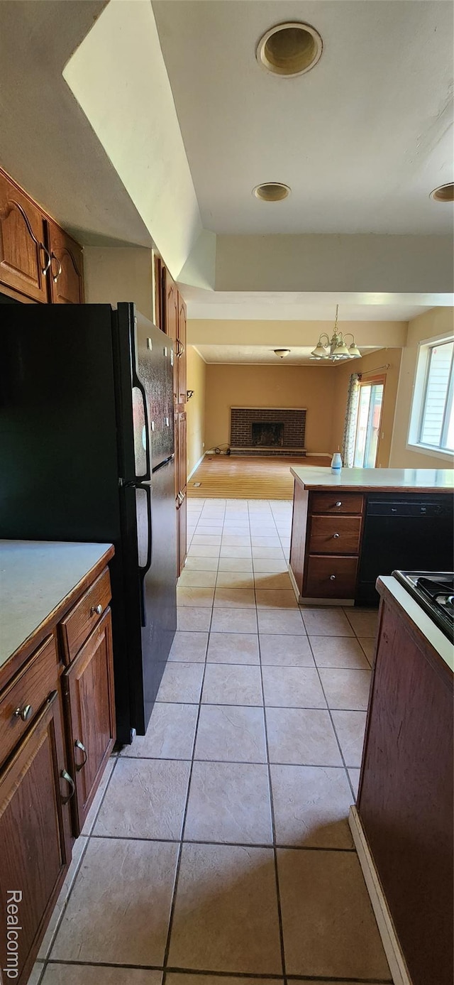 7040 Banks, Waterford, MI 48327 - kitchen featuring freestanding refrigerator, a chandelier, light tile patterned flooring, and open floor plan