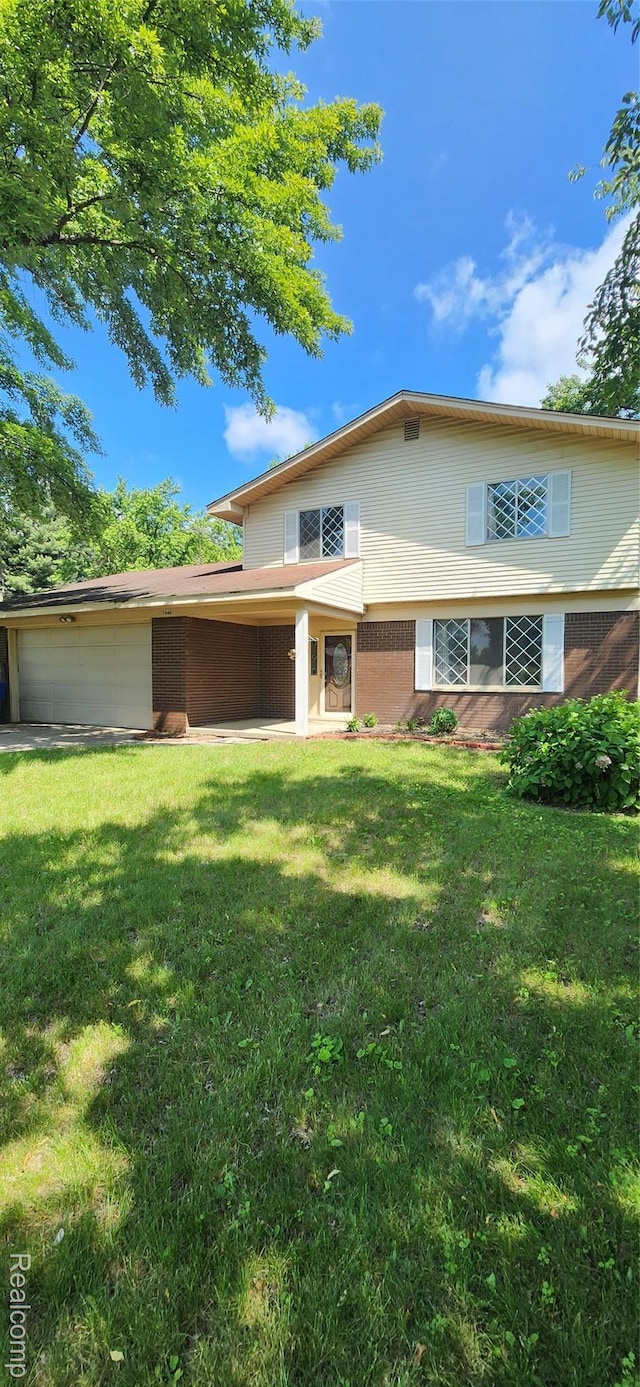 7040 Banks, Waterford, MI 48327 - view of front of home featuring a front yard, an attached garage, and brick siding