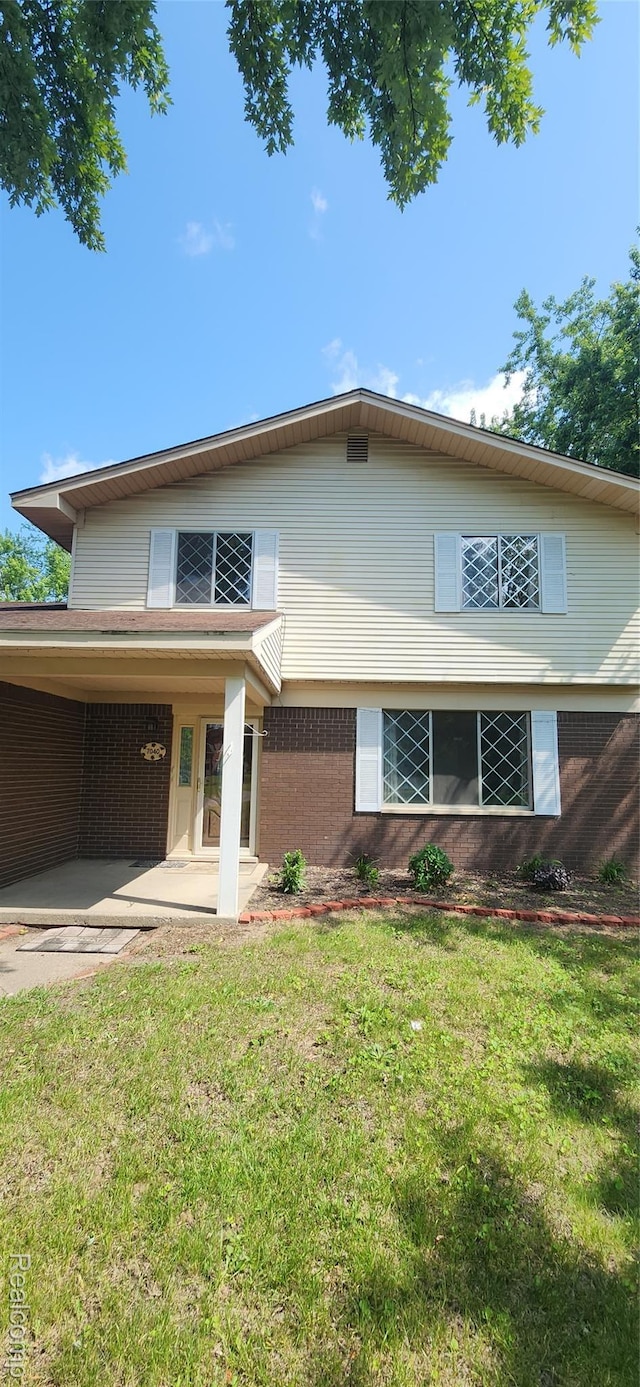 7040 Banks, Waterford, MI 48327 - view of front facade with brick siding and a front lawn