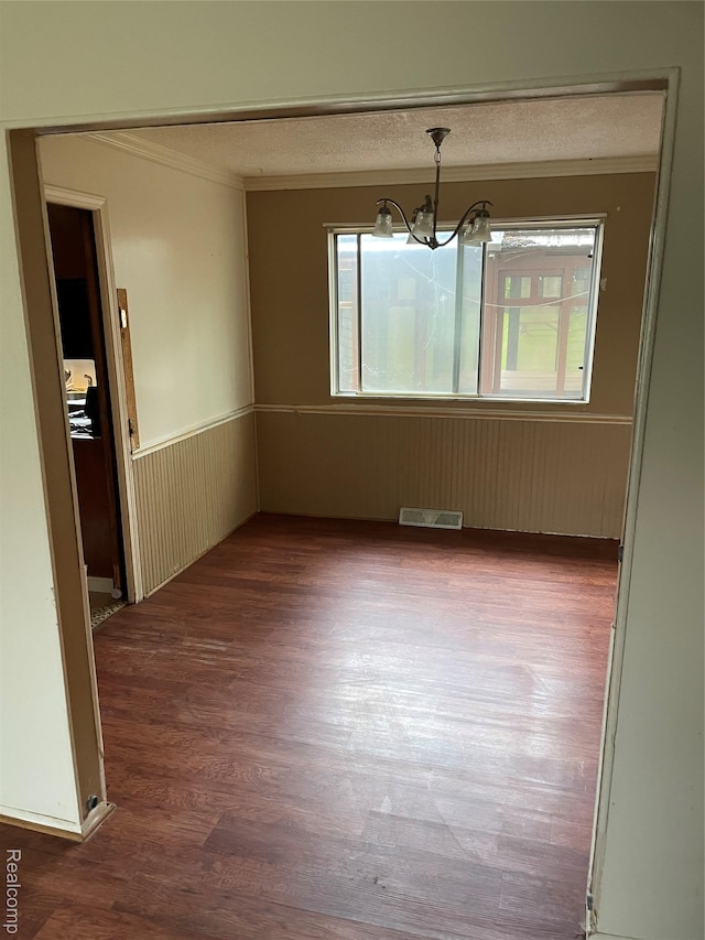 7040 Banks, Waterford, MI 48327 - unfurnished dining area featuring ornamental molding, dark wood finished floors, a chandelier, a wainscoted wall, and a textured ceiling