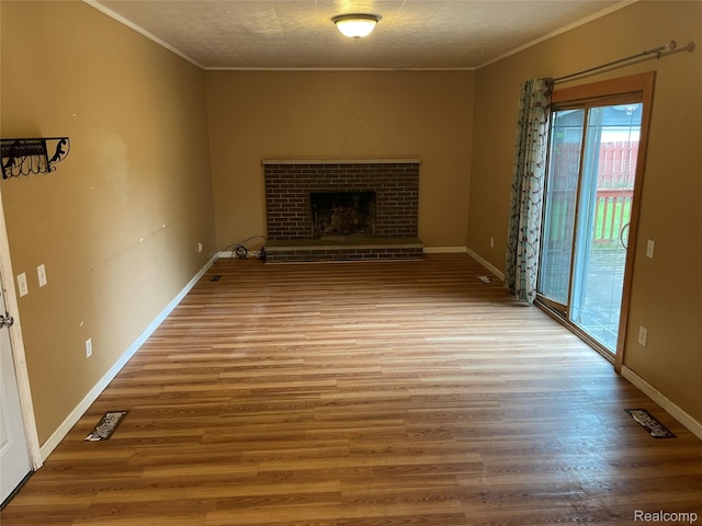 7040 Banks, Waterford, MI 48327 - unfurnished living room with ornamental molding, wood finished floors, and a brick fireplace