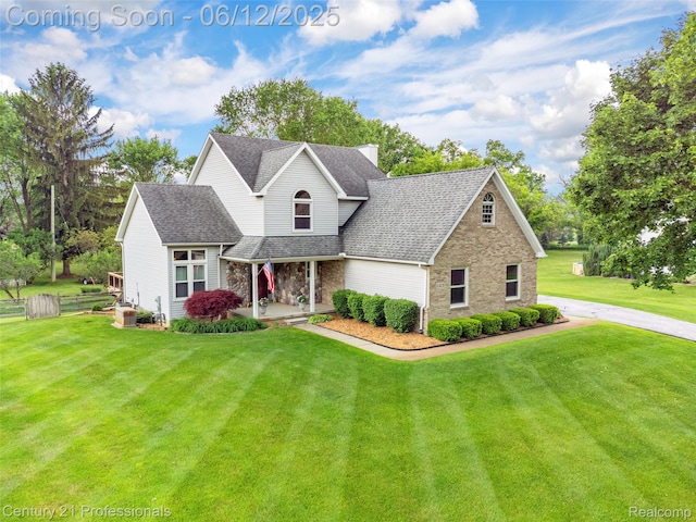 11213 Youngstree Ct, Davisburg, MI 48350 - traditional-style house featuring a shingled roof, brick siding, and a porch