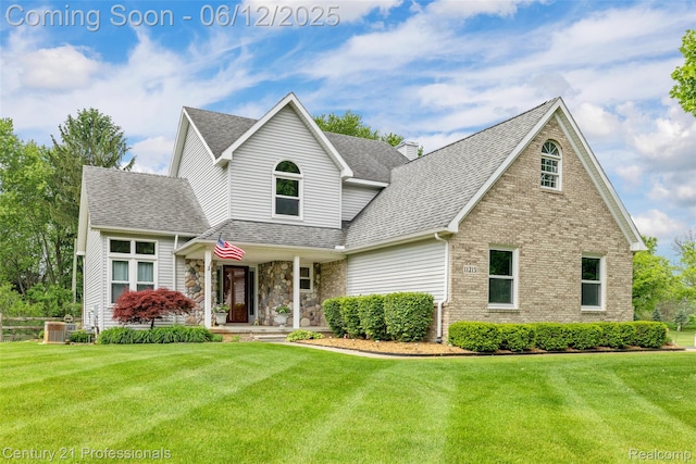 11213 Youngstree Ct, Davisburg, MI 48350 - traditional-style house with a front lawn, roof with shingles, brick siding, and central AC unit