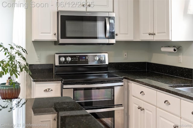 11213 Youngstree Ct, Davisburg, MI 48350 - kitchen with stainless steel appliances, white cabinetry, and dark stone countertops