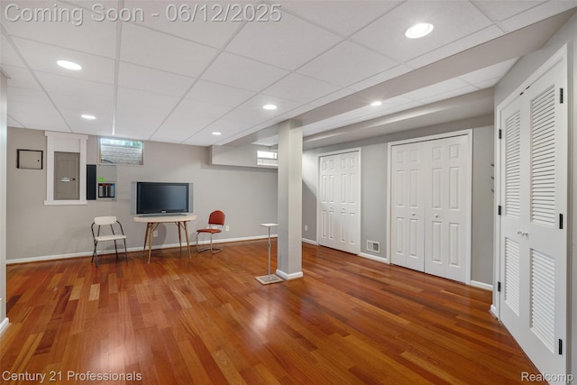 11213 Youngstree Ct, Davisburg, MI 48350 - unfurnished living room with baseboards, wood finished floors, and a paneled ceiling