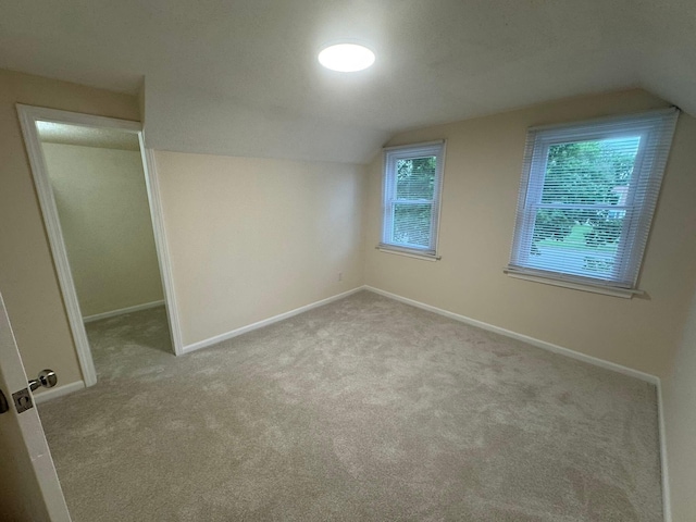 829 S Union St, Tecumseh, MI 49286 - unfurnished bedroom with vaulted ceiling, carpet flooring, and baseboards