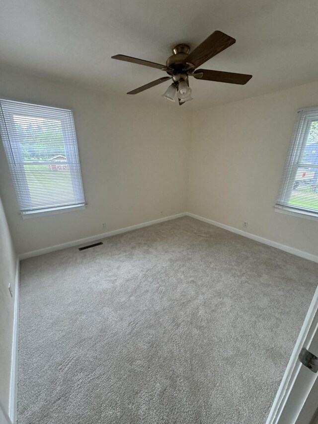 829 S Union St, Tecumseh, MI 49286 - carpeted empty room with a ceiling fan and baseboards