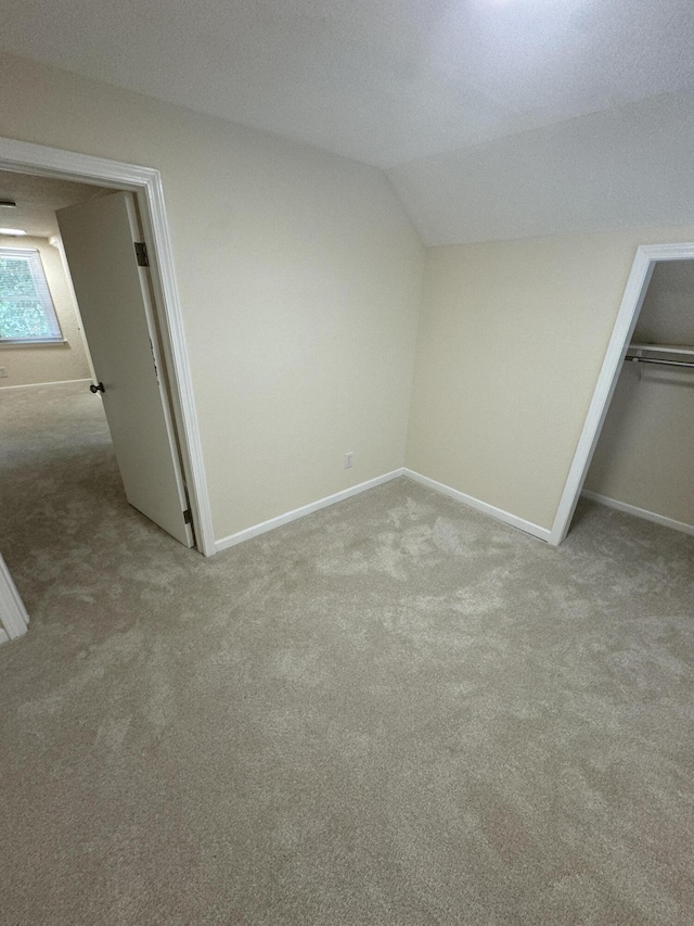 829 S Union St, Tecumseh, MI 49286 - unfurnished bedroom featuring carpet flooring, baseboards, vaulted ceiling, and a closet