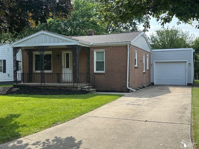 653 Huber Dr, Monroe, MI 48162 - view of front facade with brick siding, a porch, a front yard, concrete driveway, and a chimney