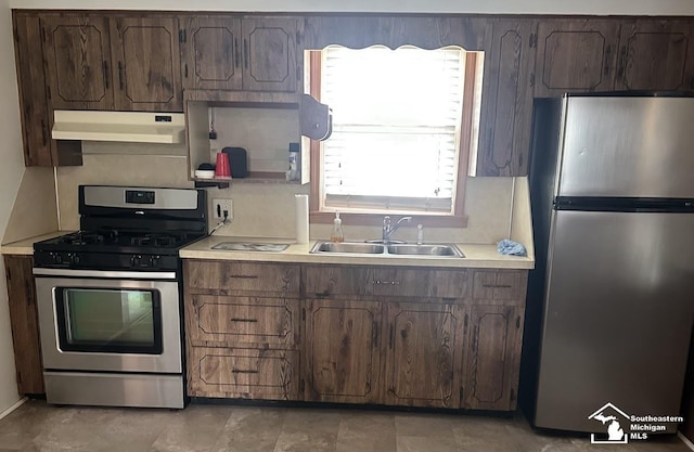 653 Huber Dr, Monroe, MI 48162 - kitchen featuring stainless steel appliances, under cabinet range hood, light countertops, and dark brown cabinetry