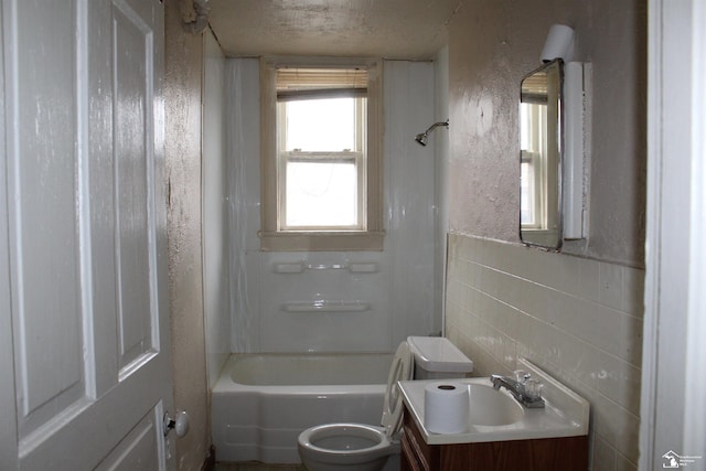 653 Huber Dr, Monroe, MI 48162 - full bathroom featuring vanity, shower / bathtub combination, tile walls, and a textured ceiling