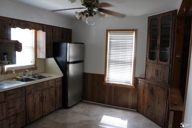 653 Huber Dr, Monroe, MI 48162 - kitchen featuring wainscoting, freestanding refrigerator, wooden walls, ceiling fan, and light countertops
