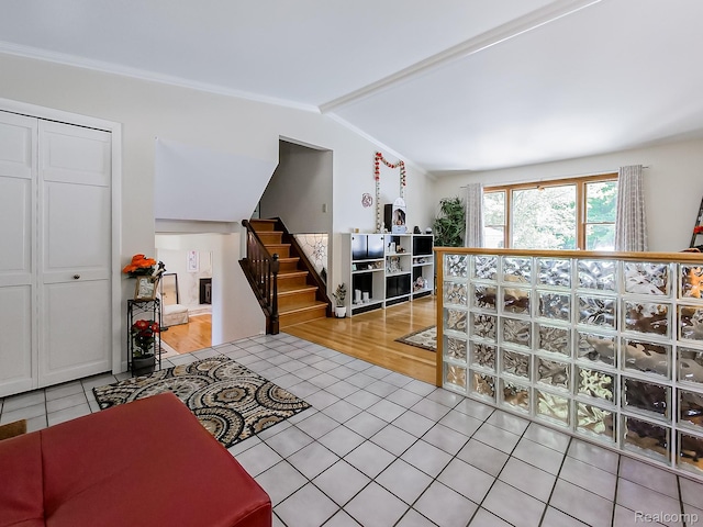 19394 Ingram Dr, Shelby Twp, MI 48038 - living area with light tile patterned flooring, stairway, and vaulted ceiling