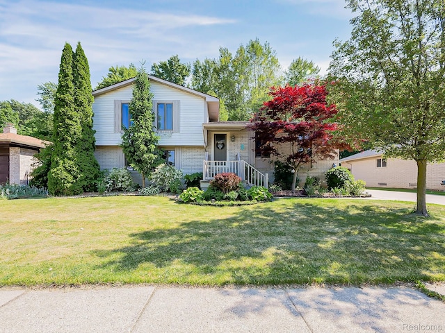 19394 Ingram Dr, Shelby Twp, MI 48038 - tri-level home with brick siding and a front yard