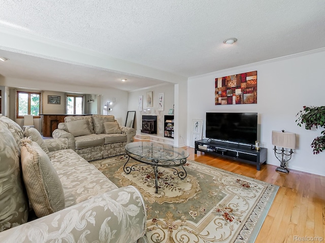 19394 Ingram Dr, Shelby Twp, MI 48038 - living area featuring wood finished floors, a textured ceiling, and ornamental molding