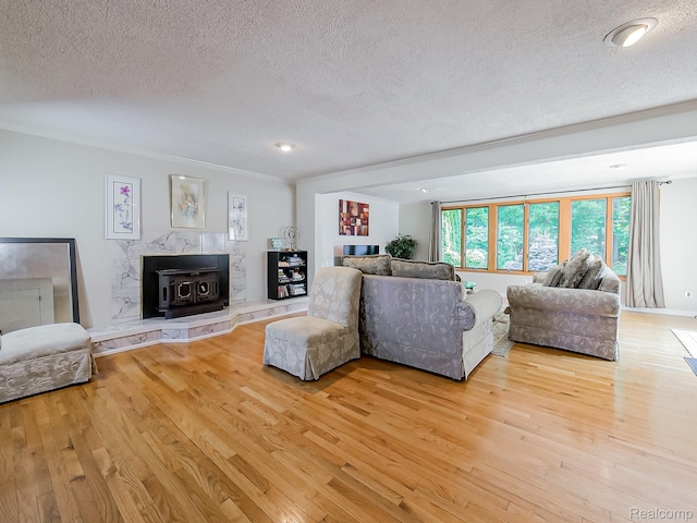 19394 Ingram Dr, Shelby Twp, MI 48038 - living area featuring a textured ceiling, a wood stove, light wood-style floors, ornamental molding, and recessed lighting