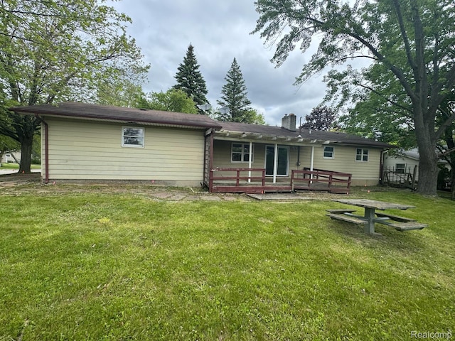 1396 Westerrace Dr, Flint, MI 48532 - rear view of house featuring a wooden deck, a chimney, and a lawn