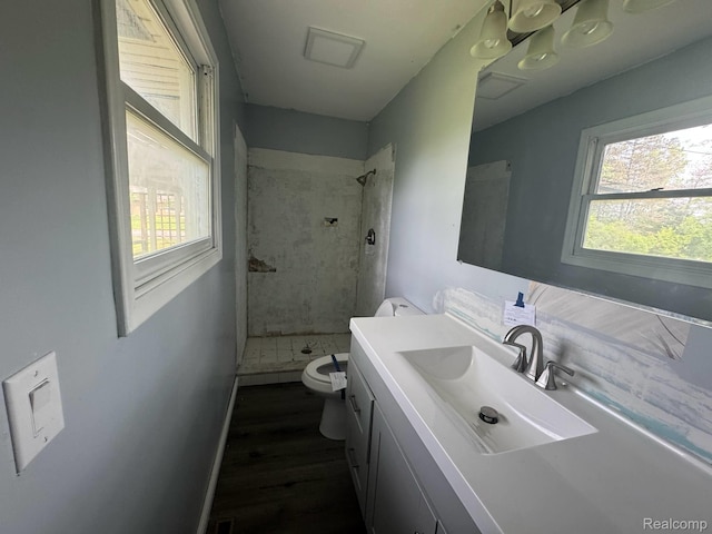 1396 Westerrace Dr, Flint, MI 48532 - bathroom with toilet, a shower stall, vanity, wood finished floors, and baseboards