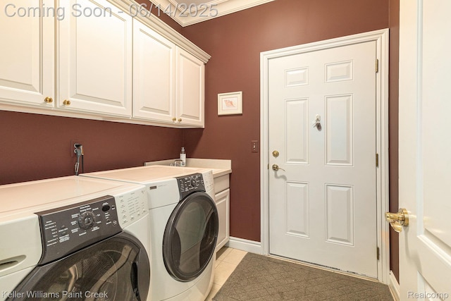 50021 Ludwig Ct, Shelby Twp, MI 48317 - laundry area with cabinet space, washer and clothes dryer, light tile patterned floors, and baseboards