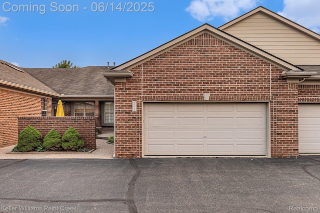 50021 Ludwig Ct, Shelby Twp, MI 48317 - view of front facade with brick siding, asphalt driveway, a shingled roof, and a garage