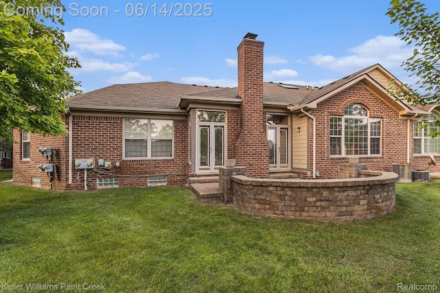 50021 Ludwig Ct, Shelby Twp, MI 48317 - rear view of house with brick siding, a lawn, a chimney, central AC unit, and roof with shingles