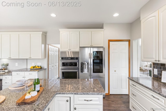 49093 Poppleton Ct, Canton, MI 48187 - kitchen with stainless steel appliances, recessed lighting, white cabinetry, and light stone counters