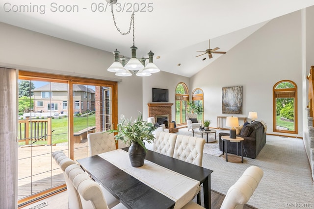 49093 Poppleton Ct, Canton, MI 48187 - dining space featuring ceiling fan, plenty of natural light, a chandelier, high vaulted ceiling, and a fireplace