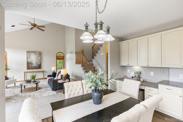 49093 Poppleton Ct, Canton, MI 48187 - dining area with stairway, high vaulted ceiling, a chandelier, a ceiling fan, and dark wood-type flooring