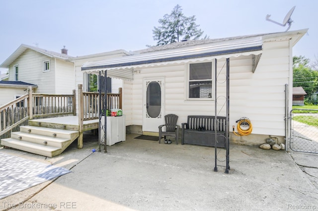 1329 Knight Ave, Flint, MI 48503 - rear view of property featuring a wooden deck, a patio area, and a gate
