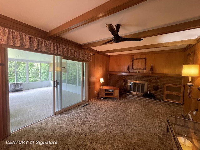 1045 N Pinecrest Ln, Grand Blanc, MI 48439 - living room with carpet flooring, beamed ceiling, wooden walls, a ceiling fan, and a brick fireplace