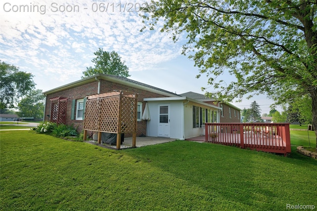 8351 Duffield Rd, Gaines, MI 48436 - back of house featuring a lawn, brick siding, a wooden deck, and a patio area