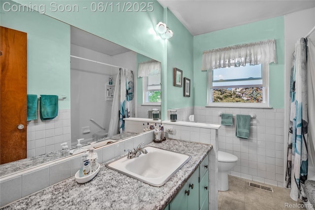 8351 Duffield Rd, Gaines, MI 48436 - full bath featuring tile walls, vanity, toilet, a shower with shower curtain, and tile patterned flooring