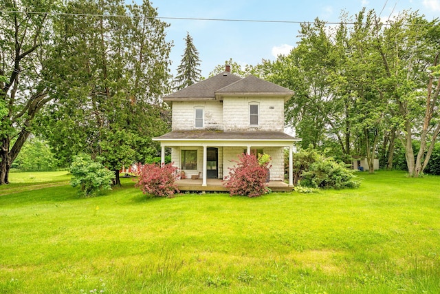 1820 E Rocky Weed Rd, Berrien Springs, MI 49103 - view of front of home featuring a front lawn, a porch, a shingled roof, and a chimney