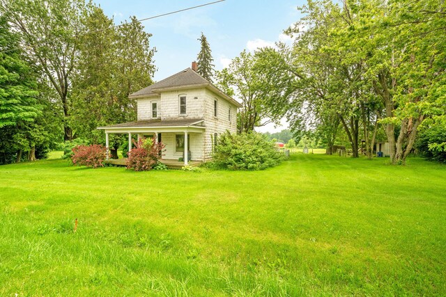 1820 E Rocky Weed Rd, Berrien Springs, MI 49103 - view of green lawn with a porch