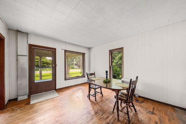 1820 E Rocky Weed Rd, Berrien Springs, MI 49103 - dining area with wood-type flooring, baseboards, and wood walls