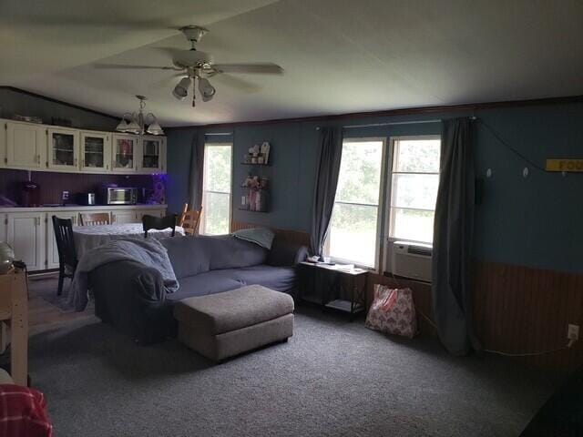 15754 N 10th Ave, Marion, MI 49665 - carpeted living room with a ceiling fan, vaulted ceiling, and a chandelier