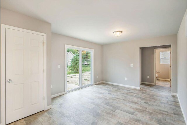 13678 Oasis Ave, Holland, MI 49424 - empty room featuring light wood-style flooring and baseboards