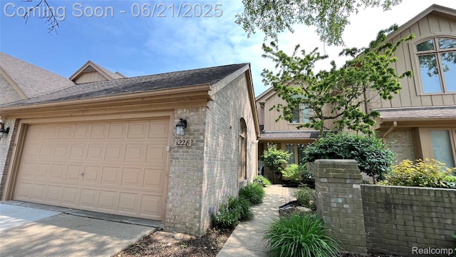1228 Autumn Dr, Troy, MI 48098 - view of home's exterior featuring brick siding, a shingled roof, board and batten siding, and a garage