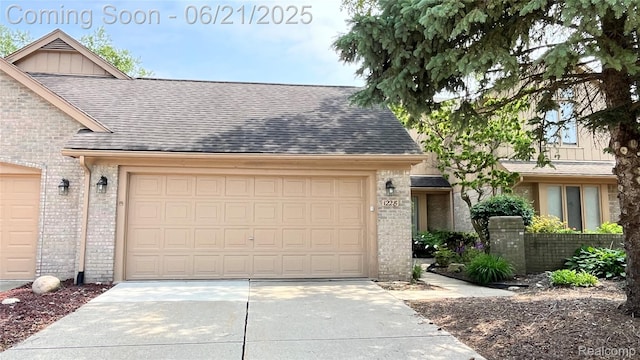 1228 Autumn Dr, Troy, MI 48098 - view of front of home with brick siding, concrete driveway, an attached garage, and board and batten siding